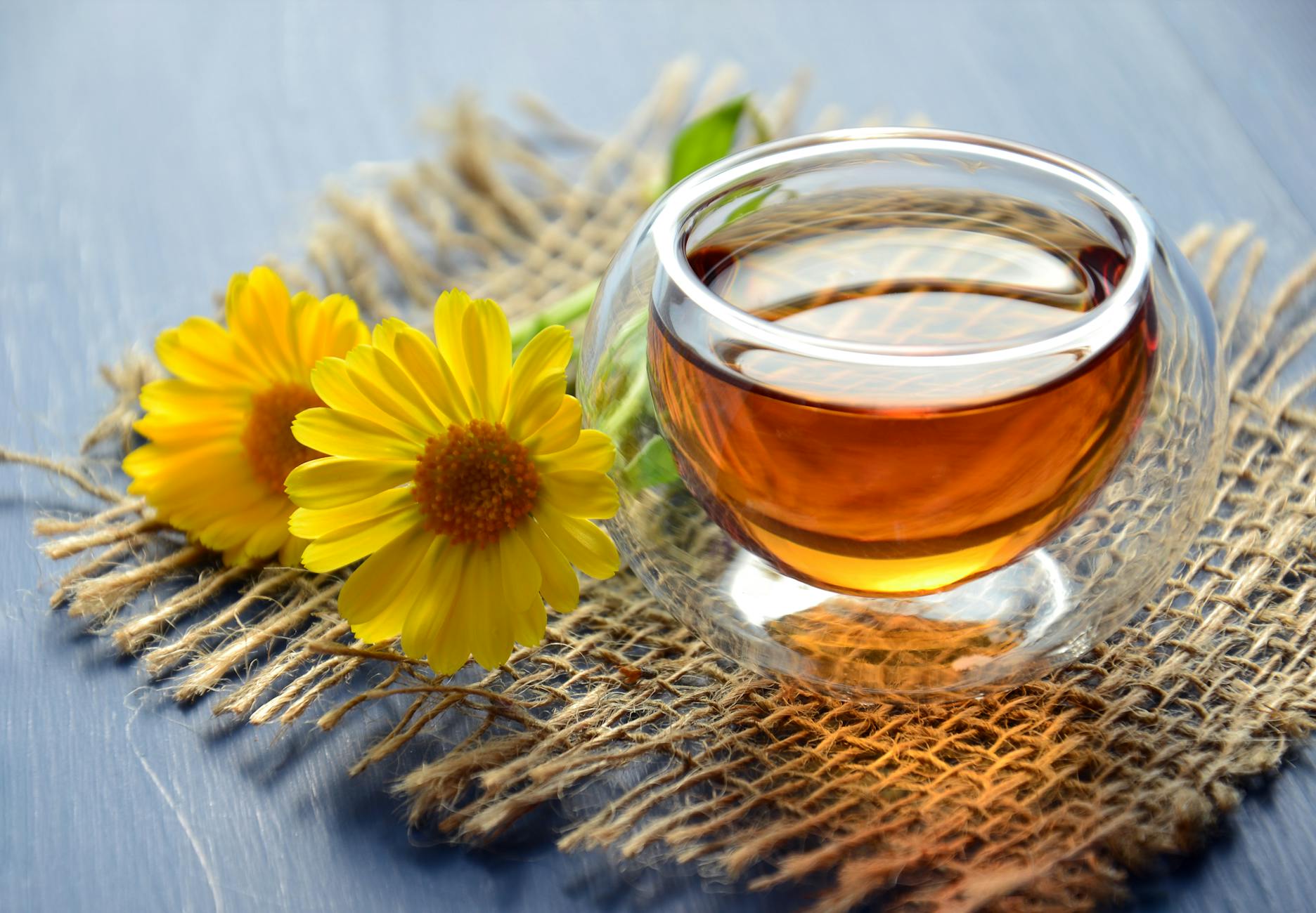 clear glass bowl beside yellow flower - best ayurvedic medicine for dry cough